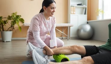 doctor-helping-patient-rehabilitation